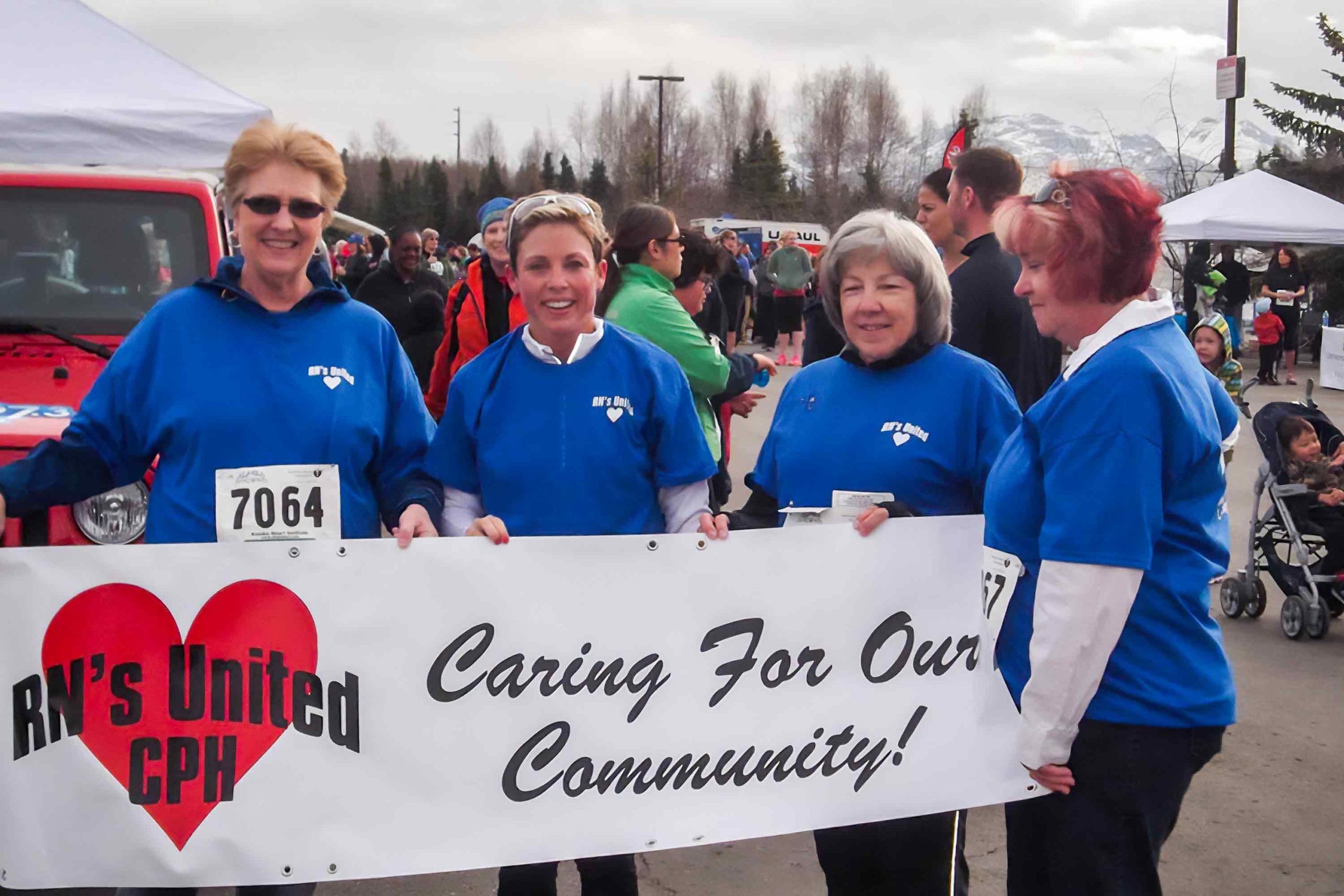 nurses supporting community running event
